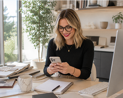 Business owner reviewing marketing on her phone