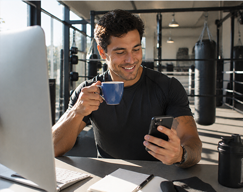Fitness business owner reviewing marketing on his phone